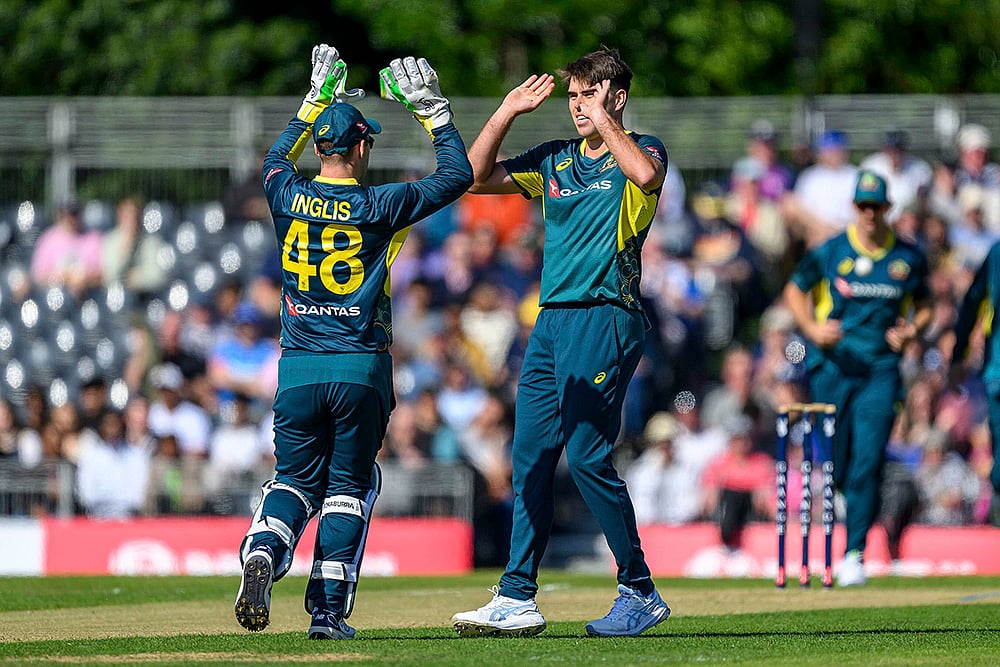 | Photo: Malcolm Mackenzi/PA via AP : Scotland Vs Australia, 1st T20I: Josh Inglis of Australia, left, celebrates with his teammate Xavier Bartlett, right, after he takes a wicket 